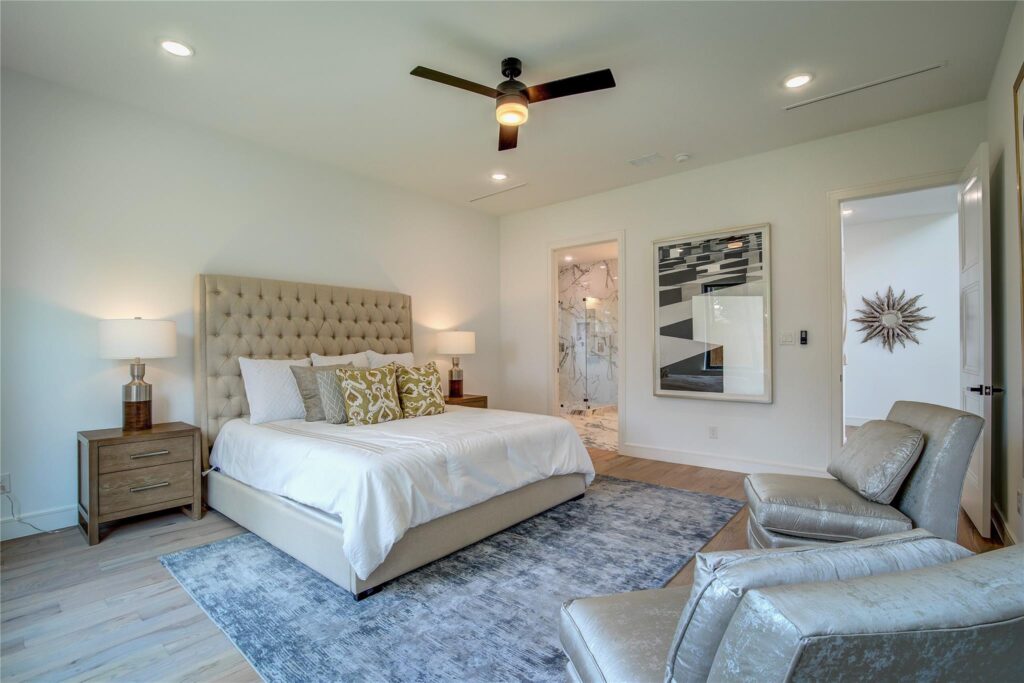 Elegant bedroom with tufted headboard and modern decor.