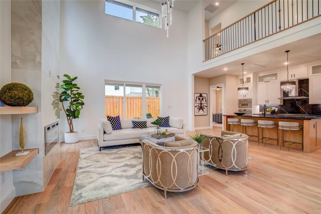 Bright, modern living room with high ceilings and cozy seating.