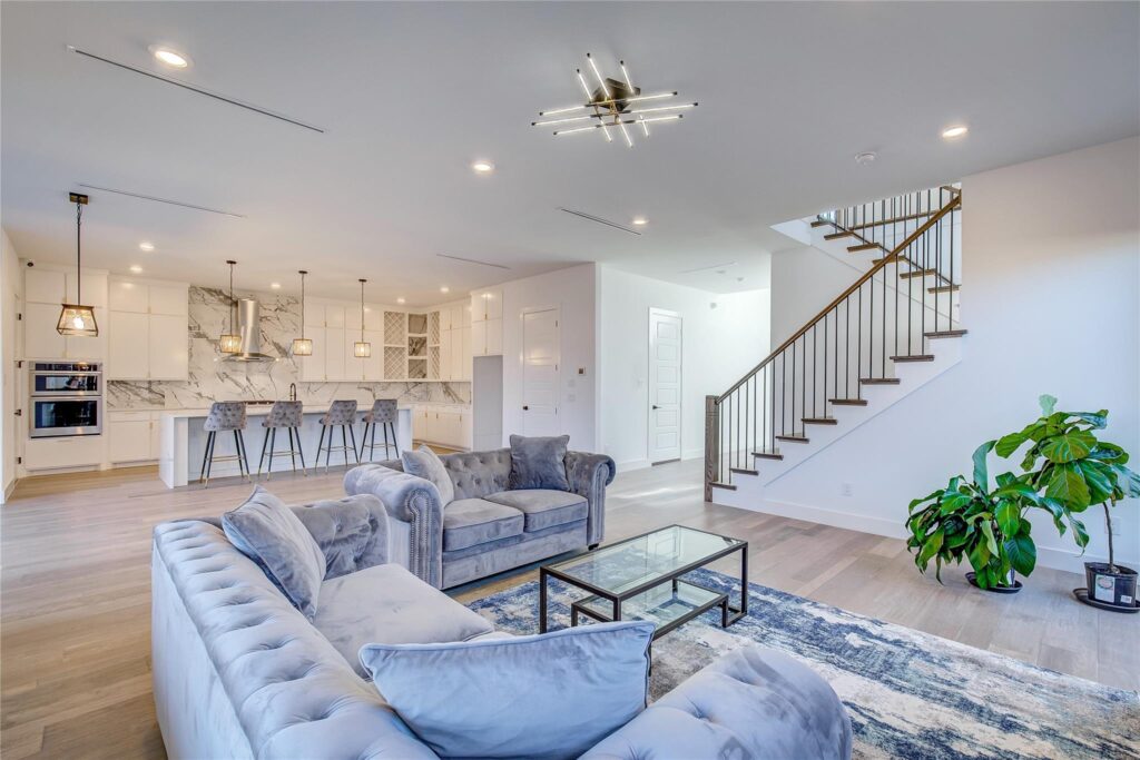 Bright, modern living room with stylish furniture and open kitchen.