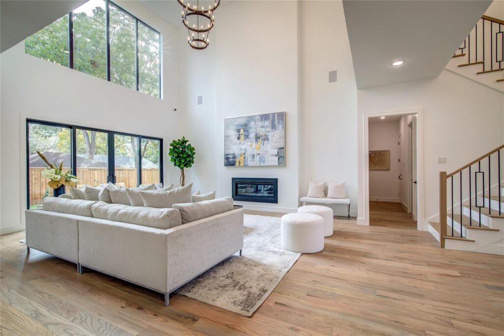 Bright modern living room with large windows and minimalist decor.